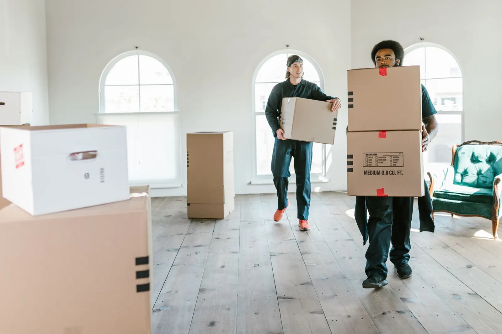 Movers carrying boxes into a home